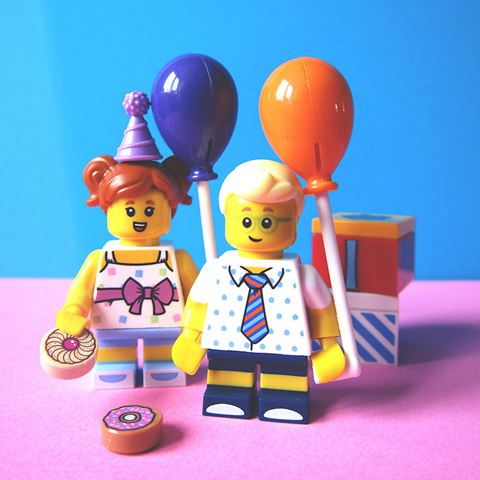 two lego figures that are celebrating a birthday