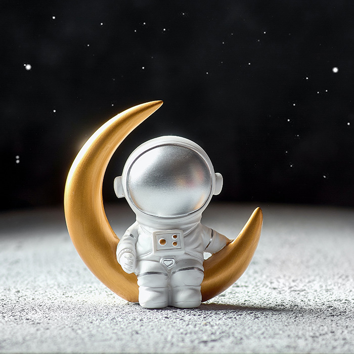 digital astronaut sitting on a moon in the dark galaxy